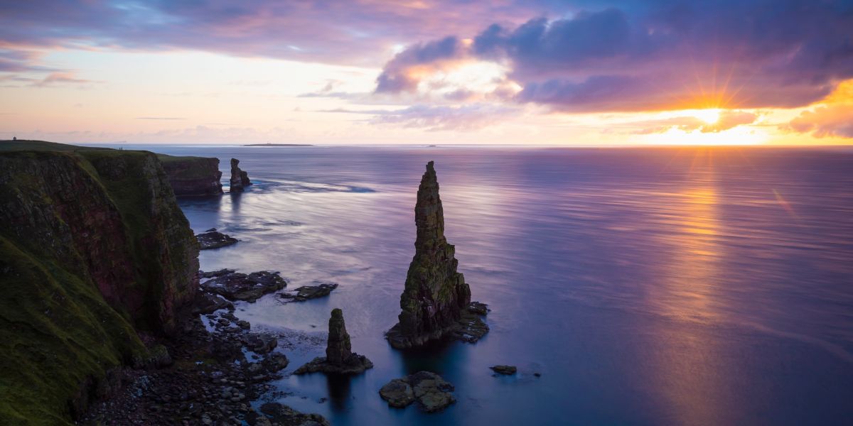 Duncansby Stacks with the sun shining across the water