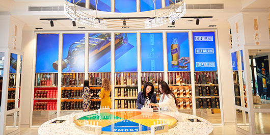 People browse a whisky exhibit 