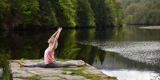 A woman practicing Yoga and Wellness at Loch Faskally