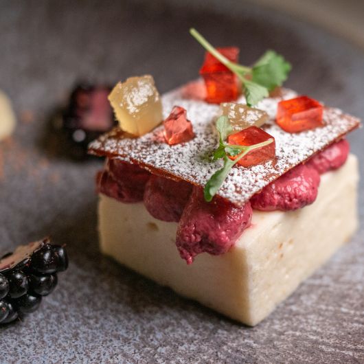 Square pear mousse dessert with autumnal berries