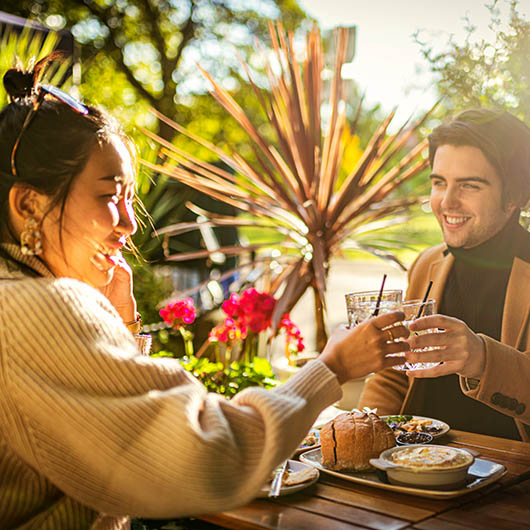Couple having meal outside on sunny day