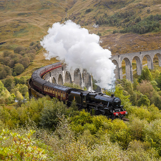 The Jacobite steam train passing over Glenfinnan Viaduct